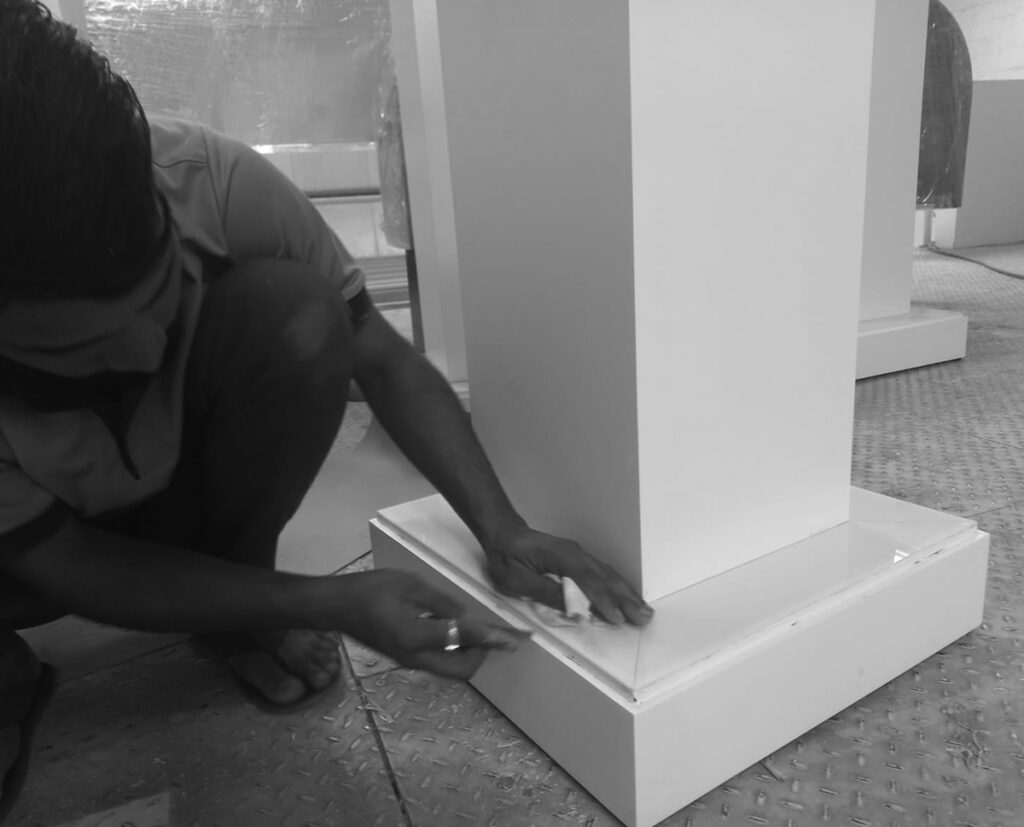 A carpenter measuring and cutting wood for a project