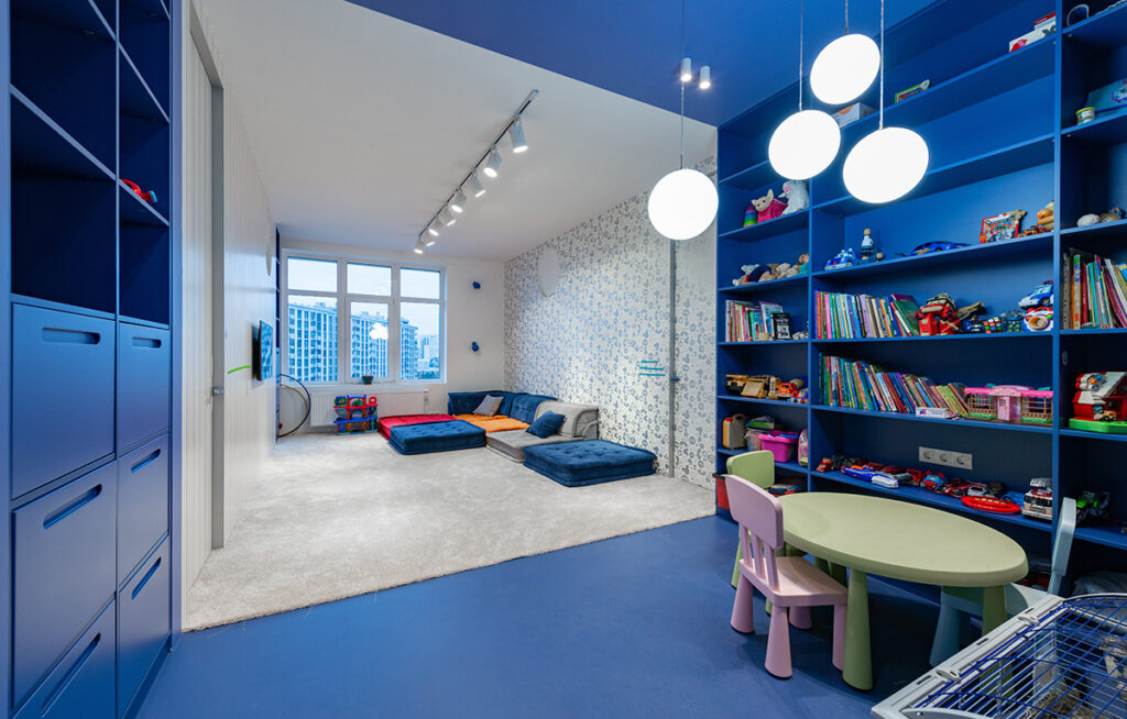 A colorful, inviting playroom with designated areas for various activities