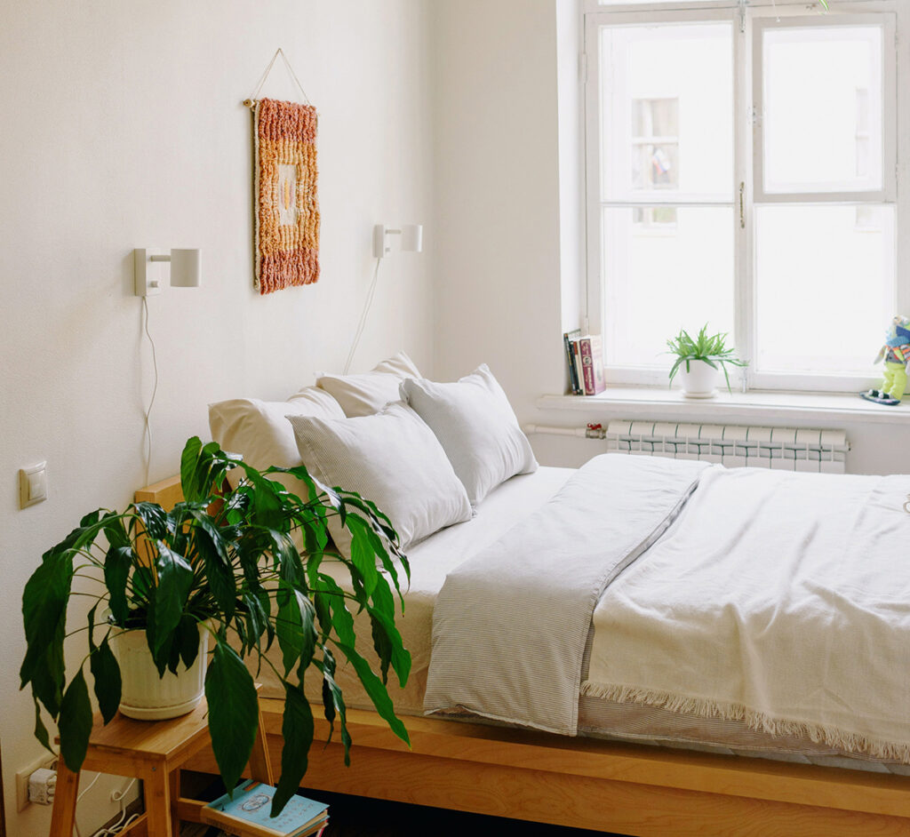 bedroom with natural light and greenery