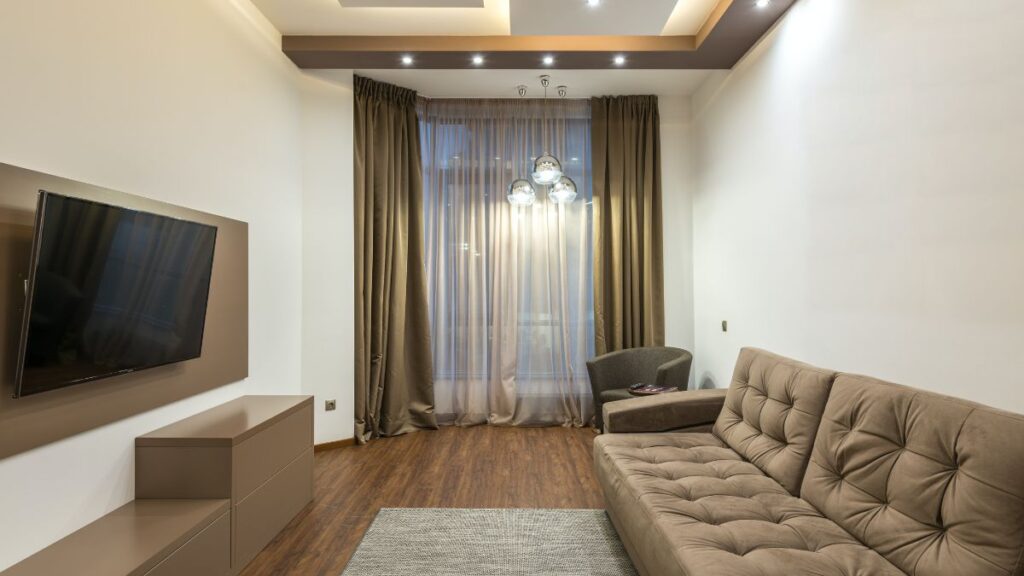 image of a living room with floor-to-ceiling curtains showcasing elegance and light filtering